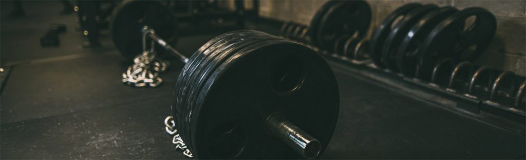 Heavy barbell with weights in gym.