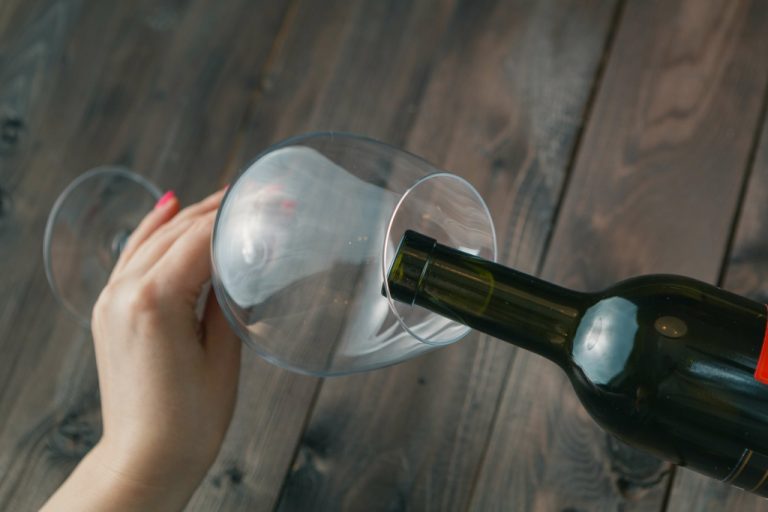 Pouring wine into a glass.
